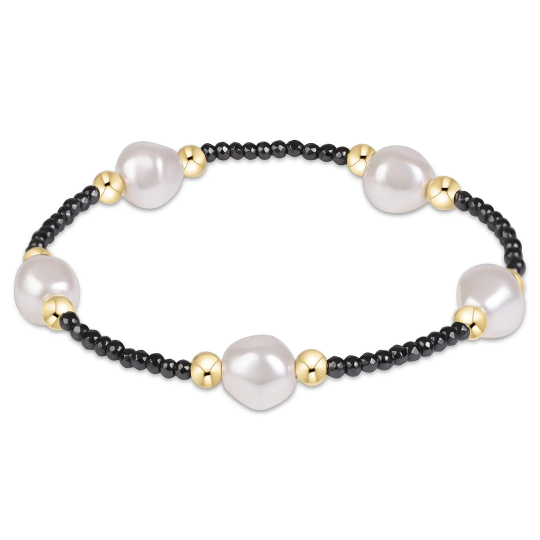 Enewton 2mm beaded faceted hematite and large crystal pearl bracelet on white background. 